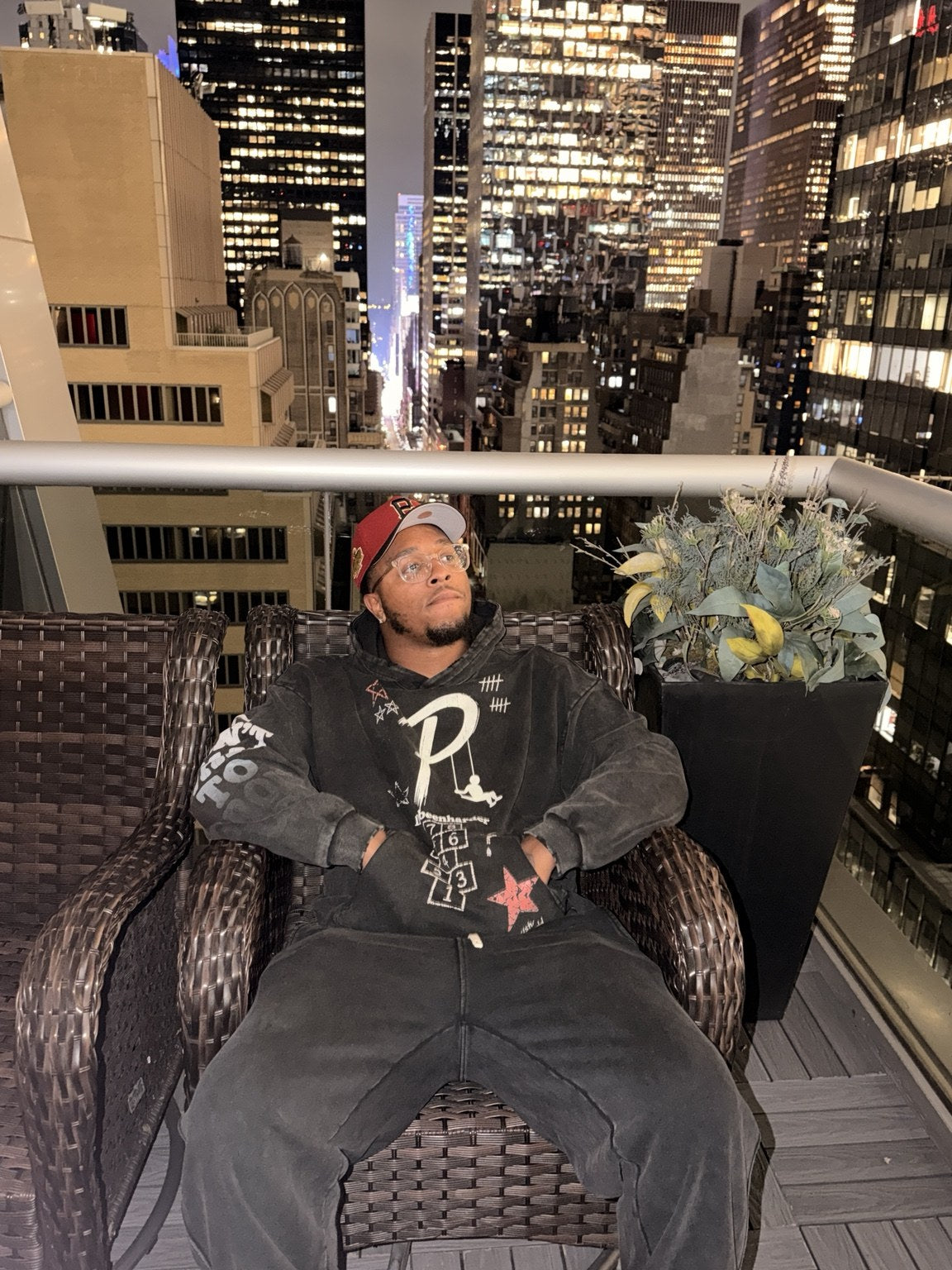 Front artwork of the Playground hoodie worn on a rooftop